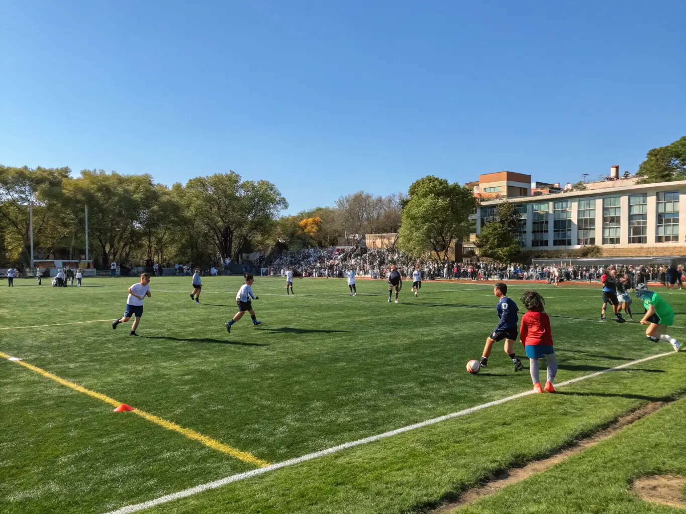 A team of students playing football on the school field, illustrating the excitement and camaraderie of team sports.